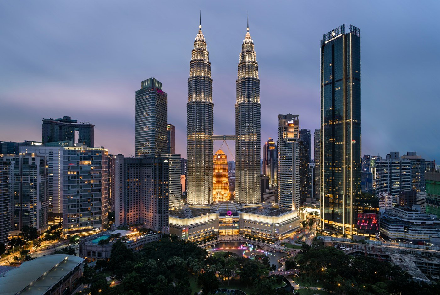 Illuminated Petronas Twin Towers at dusk