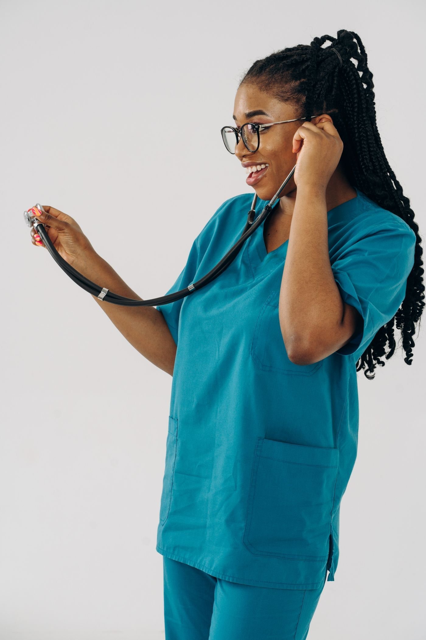 A smiling healthcare professional wears a stethoscope.