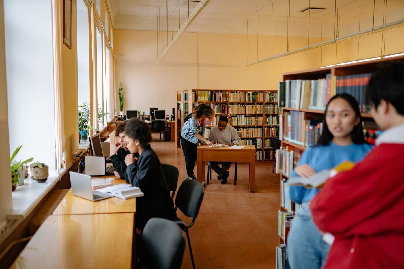 University students study together at a library table.