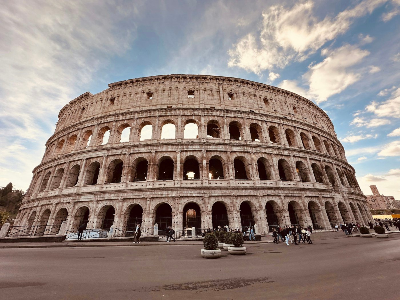 Arched stone exterior of the Colosseum in daylight