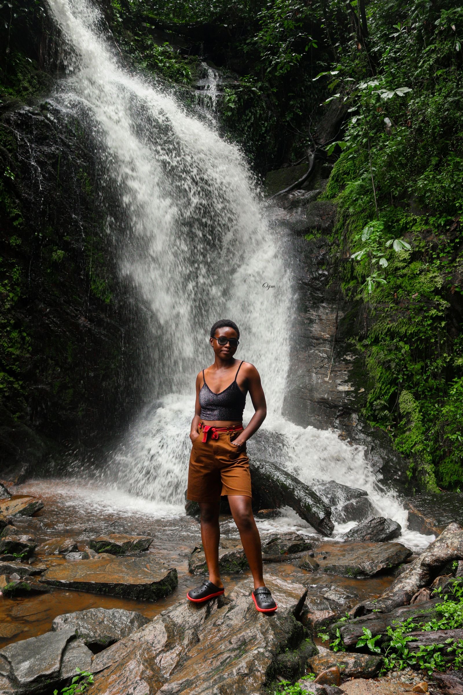 Traveller standing before Kintampo waterfall in Ghana